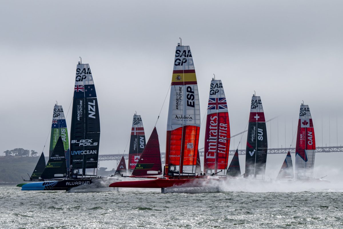 Australia SailGP Team helmed by Tom Slingsby and New Zealand SailGP Team helmed by Peter Burling lead the fleet past the Golden Gate Bridge ahead of the SailGP Season 4 Grand Final in San Francisco, USA. Friday 12th July 2024. Photo: Ricardo Pinto for SailGP. Handout image supplied by SailGP